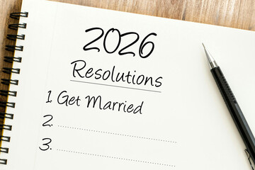 Handwritten 2026 resolution Get Married on a notebook, symbolizing New Years goals and future life planning