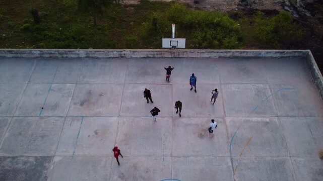 High angle shot of people playing on a basketball court during the daytime