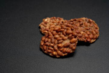 Fried peanut cookies on black background, Beans over rice crispy plate, Thai food.