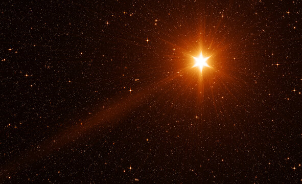 Bright Golden Christmas Star with Rays in the Starry Sky