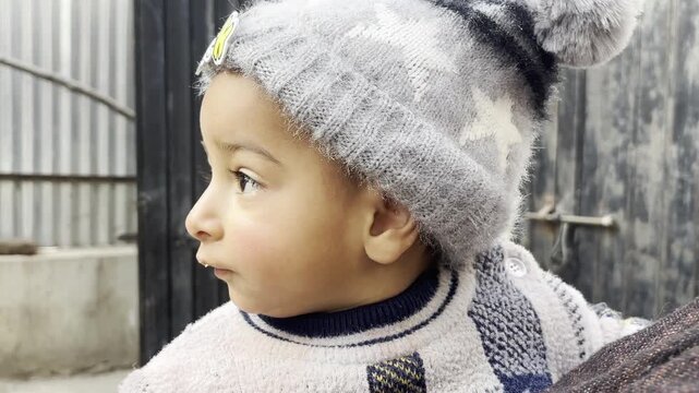 Closeup side view of Asian baby boy dancing on the music on mother's lap. Cute baby boy playing and dancing on music development of mental health and physical health.