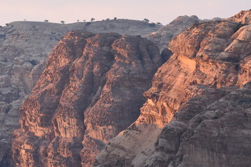 Majestic rock formations in the evening light at a desert location showcasing cliffs and surrounding hills