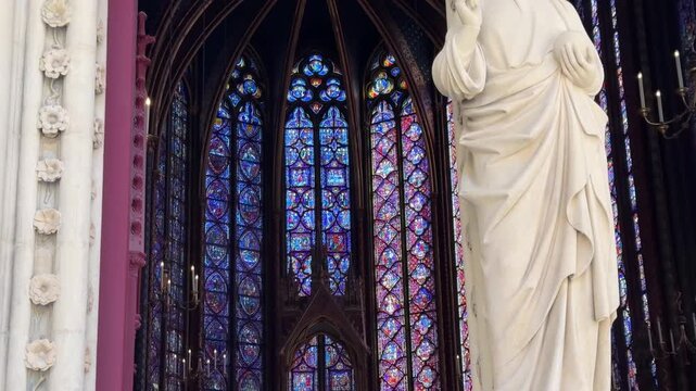 Interior details of Sainte-Chapelle in Paris, France, featuring stained glass windows and Gothic architecture, ideal for travel, history, and European heritage footage.
