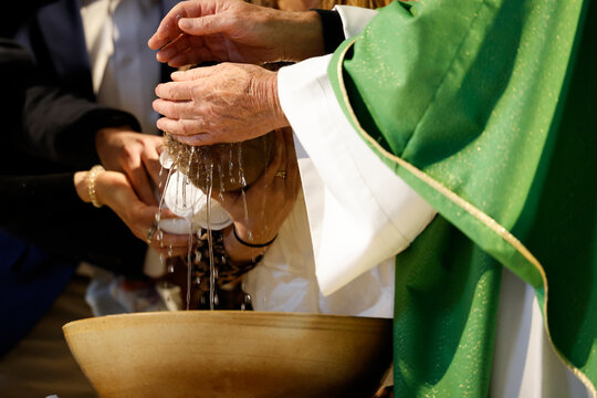 Saint Agatha Church.Baptism ceremony. The ritual of purification with water. Rumilly. France.
