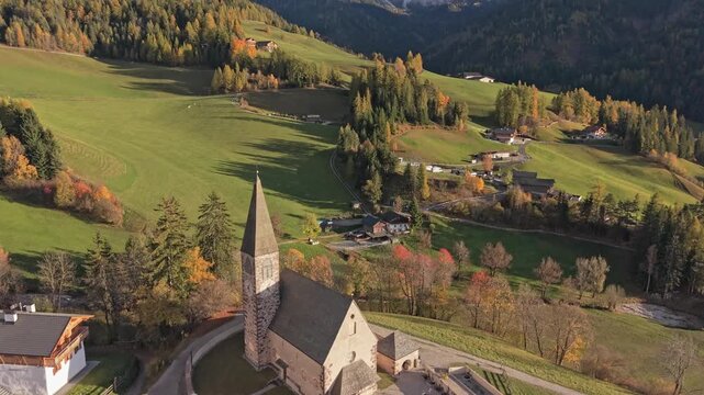 Drone shot of iconic church in Val di Funes, Dolomites, Northern Italy