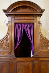 San Clemente Basilica.  Baroque confessional sacramental reconciliation inside church.