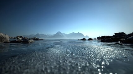 Frozen lake surface with ice, rocks, and snow capped mountains under a clear winter sky, reflecting cold landscape