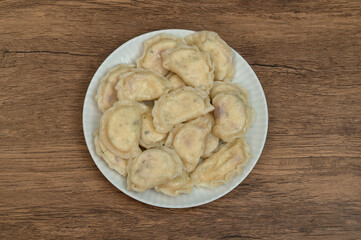 A plate full of perfectly cooked, hand-made dumplings, Polish boiled dumplings