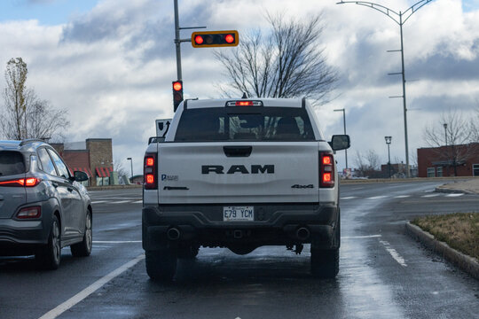 Canada, 08 November 2025 : White pickup truck waits at red light on wet road silence