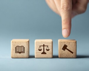 Hand pointing at wooden blocks with legal symbols