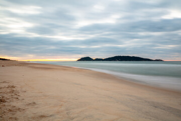 Sunrise on Campeche beach with a view of Campeche Island in Florianopolis, Santa Catarina, Brazil.