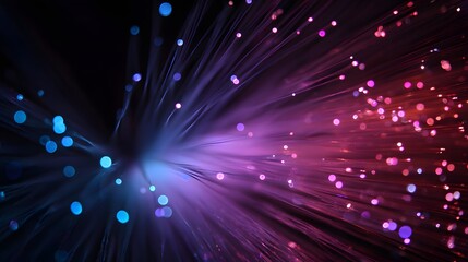 Vibrant blue and purple light burst from fiber optic strands.
