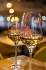 Lips with lipstick on a glass of wine in a restaurant on the table