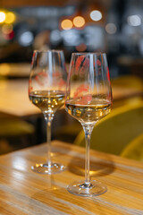 Lips with lipstick on a glass of wine in a restaurant on the table