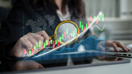 A businesswoman examines stock market trends using a magnifying glass over vibrant digital graphs and charts, representing key financial insights and opportunities. Impute