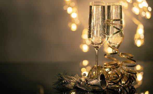 Champagne glasses with bokeh lights, perfect for celebrations - Powered by Adobe