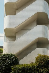 Modern architecture of a city office building with striking green glass windows reflecting the sky