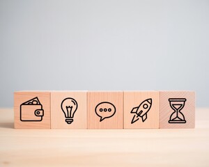 Wooden blocks displaying business icons including money idea communication launch and time management