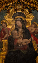 Fresco (14th century) of Blessed Virgin Mary holding baby Jesus Christ in her arms.