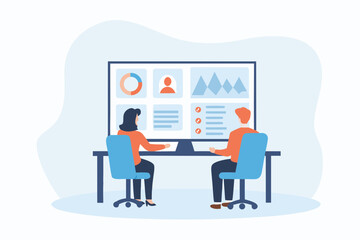 Business team analyzing data on a large screen in a meeting room