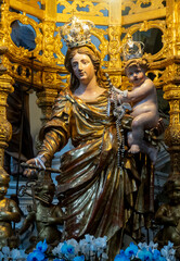 Statue (19th century) of Blessed Virgin Mary holding baby Jesus Christ in her arms.