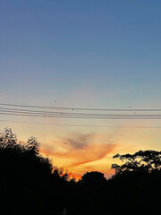 Sunset sky clouds in the Evening with Golden orange sunlight in golden hour, Dusk sky background