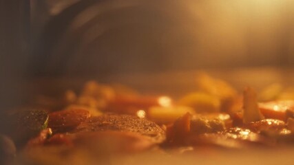 Freshly cut vegetables are baking in the oven on a baking sheet, releasing delicious aromas. This cooking process showcases healthy meal preparation at home during dinner time