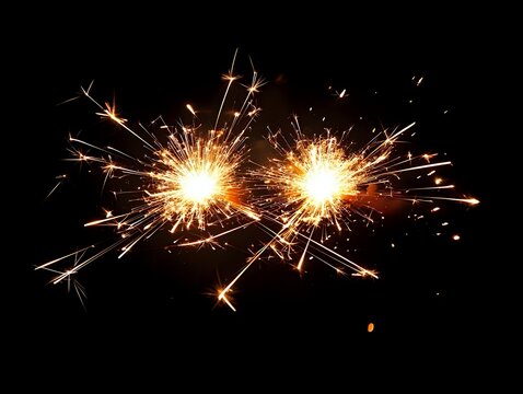 Two bright sparklers burning against black background, creating festive golden sparks and light trails for celebration or holiday events.