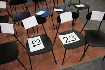 Numbered chair seat in event hall voting digits numbers
