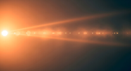 Abstract orange lens flare effect on dark background with glowing light source creating a dynamic