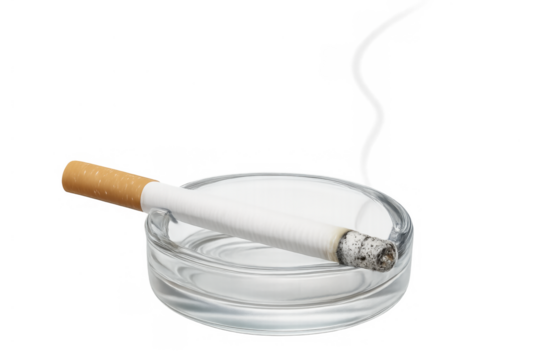 Cigarette resting in a clear glass ashtray with a long ash and filter. Representing smoking, addiction, and public health issues