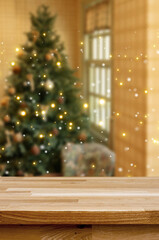 Festive Cheer Tabletop: A blurred Christmas tree stands adorned with twinkling lights in the warm room and wooden foreground