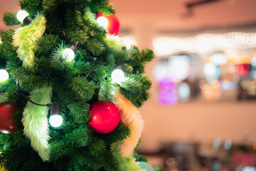 A festive Christmas tree decorated with colorful ornaments, shiny baubles, gift boxes, and holiday ribbons, creating a warm seasonal atmosphere perfect for celebration themes and winter holiday design