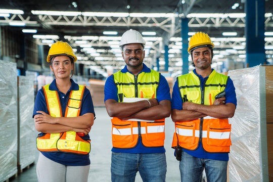 Diverse workfoce team black men,woman factory worker wear safety helmet, safety vest use tablet for industrial warehouse job.Teamwork efficient success modern logistic manufacture operation management