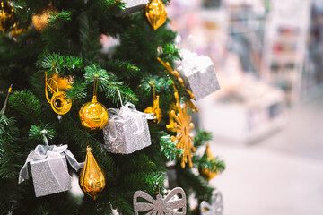 Closeup garland Christmas tree decoration,red,gold,silver ornament with bokeh background. Perfect holiday sales, winter celebration, festive seasonal promotions, marketing, shopping with copy space