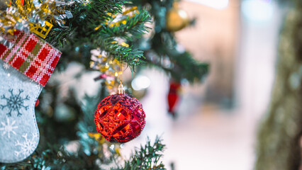 Closeup garland Christmas tree decoration,red,gold,silver ornament with bokeh background. Perfect holiday sales, winter celebration, festive seasonal promotions, marketing, shopping with copy space