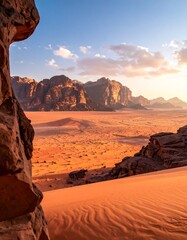 A breathtaking landscape reveals a vast, reddish desert under a vibrant sky, framed by rocky formations. The scene captures the golden hour