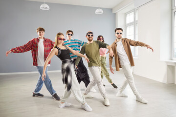 Modern dancer group, cool dancing people dancing indoors, moving posing in studio space, dance class, rehearsal in dynamic pose, enjoying practicing or performing, community having fun together