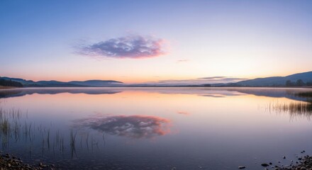 Stunning sunrise over tranquil lake reflects pastel skies and distant hills for peaceful getaway visuals