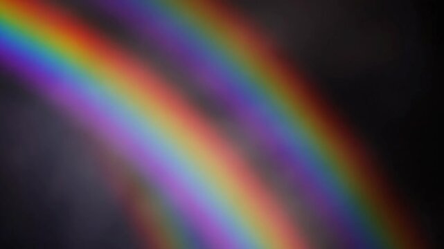 Vibrant rainbow arc dancing against dark backdrop brings feelings of hope, joy and optimism