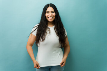 Happy young woman smiling in studio portrait