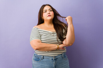 Confident plus size latin woman posing for portrait