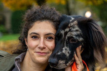 Fototapeta premium Woman and dog bonding closely outdoors, expressing companionship and love