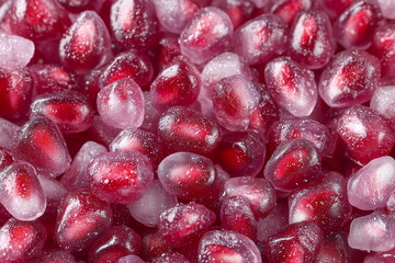 Background of frozen pomegranate seeds. Advertisement for frozen berries and fruits. 