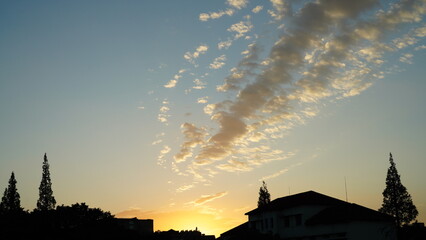 The beautiful sunset view with the buildings' silhouette and orange color sky as background in the city
