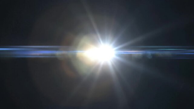 Bright lens flare effect with blue light and warm bokeh on dark background