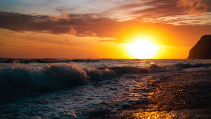 Wave of water on the ocean beach while amazing sunset. Bali.