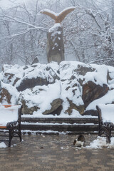 Sculpture of an Eagle in the park of resort town of Zheleznovodsk in winter with deep fog. Zheleznovodsk, Russia
