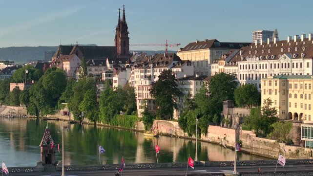 Basel City in Switzerland on Summer Morning. Orange Dawn over the Basler Munster, Church Square and Old town, Aerial.