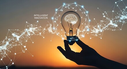 Silhouette of a hand holding a glowing light bulb containing a digital brain, surrounded by a complex abstract network against a sunset background, representing intelligent innovation.